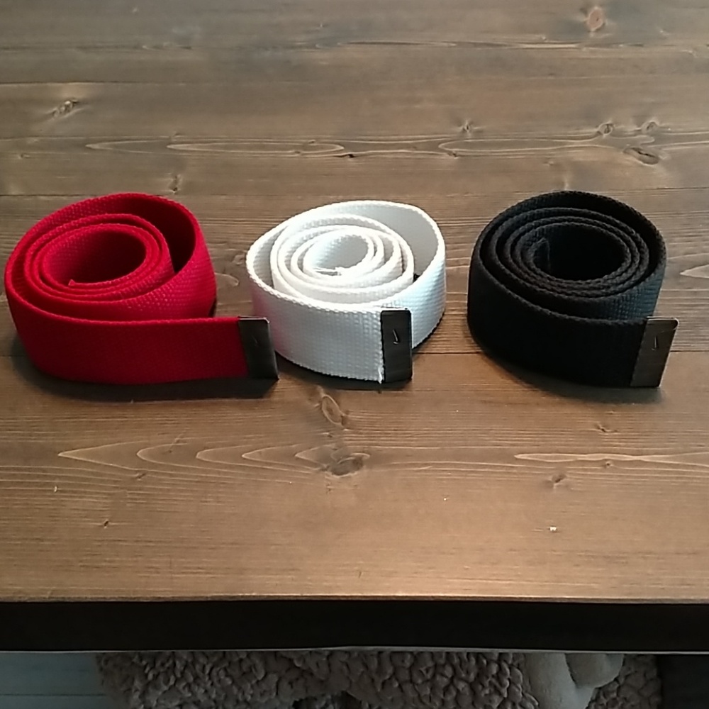 Red, white, and black Nike golf belts
